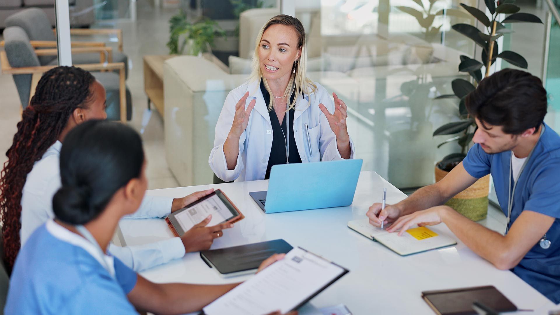 A doctor leading a discussion with healthcare professionals.